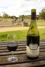 Wine and glass (bikes in background) at Evans & Tate, Margaret River