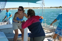 Nikki helps hoist the front sail aboard Shotover 2, Monkey Mia