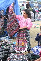 Woman folding cloth at San Francisco Market