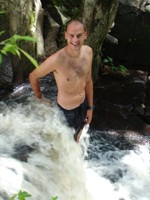 Ian cooling off (and trying to ease his sore muscles from riding!) in a waterfall in Miraflor