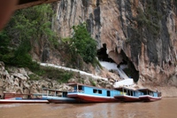 Boats on river at the Pak Ou Caves, near Luang Prabang