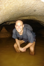 Ian ducking under low roof in Tham Hoi Cave, Vang Vieng