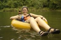 Nikki floating with beer in hand, Nam Sok River, Vang Vieng