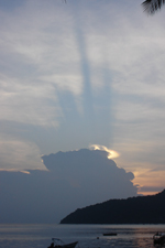 Setting sun casting shadow on cumulonimbus cloud, Pulau Perhentian Besar