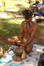 Local member of tribe beating leather to earn points for their queen contestant, Easter Island